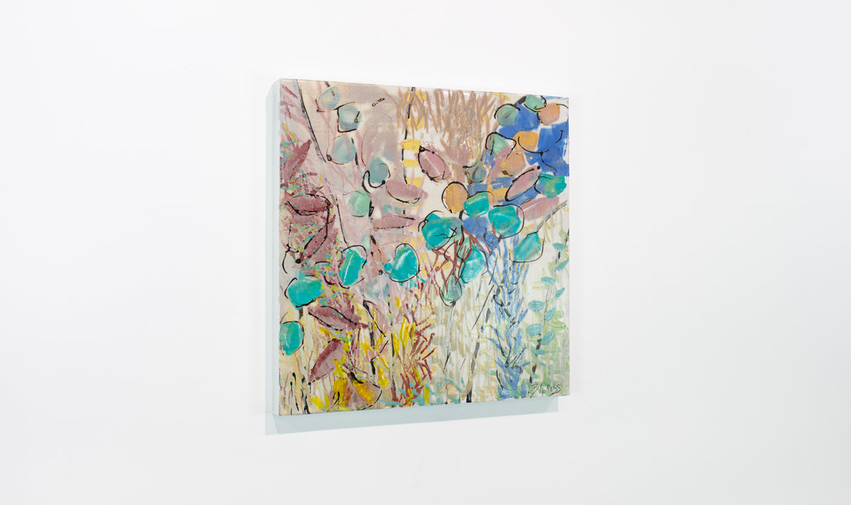 A colorful pink, yellow, and turquoise abstract painting hangs on a white wall.