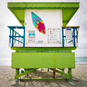 A photograph of a lime green, white, and blue lifeguard stand on Miami Beach. 