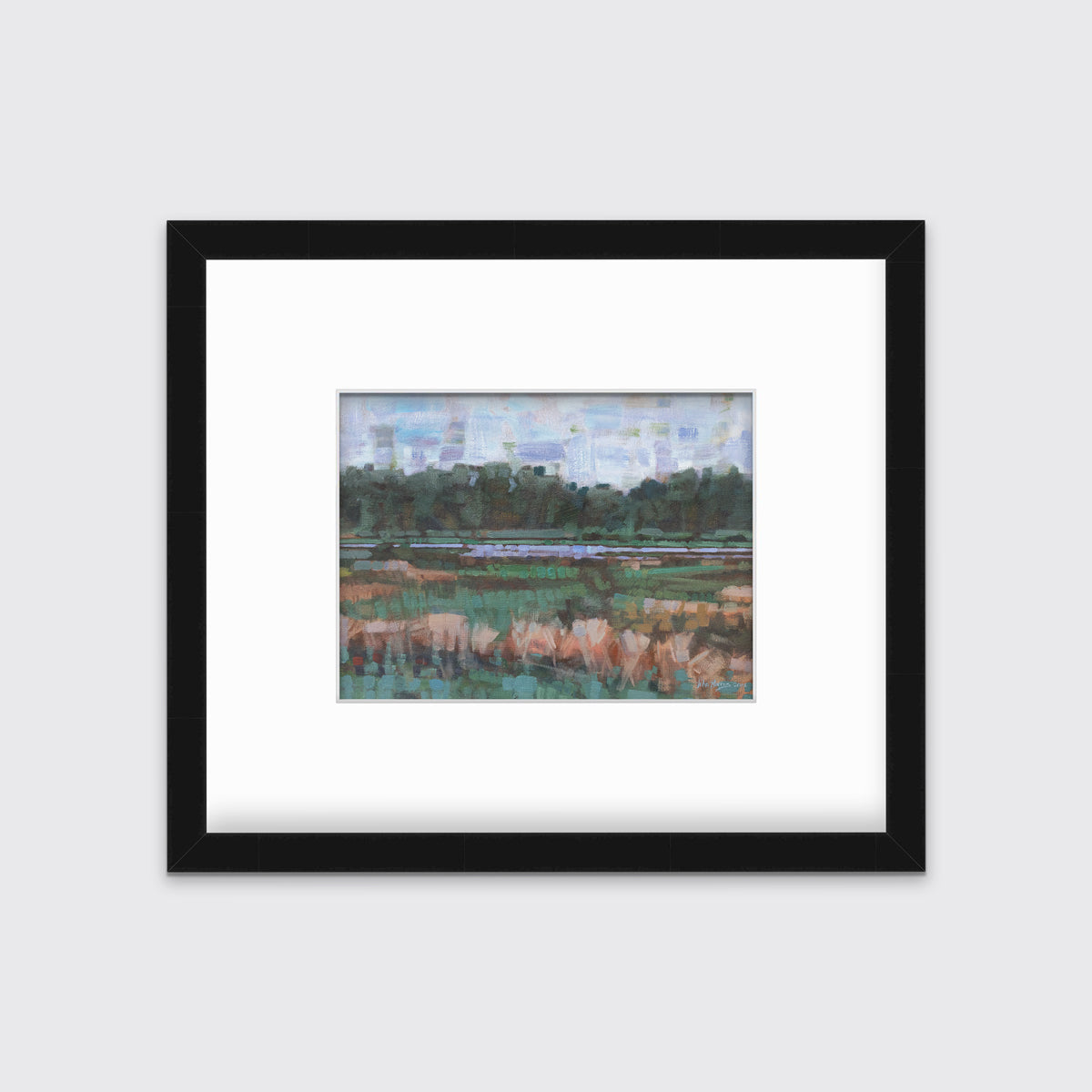 A green, orange and blue abstract landscape print in a black frame with a mat hangs on a white wall.