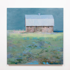 A blue and green abstract landscape painting with a brown barn hangs on a white wall.