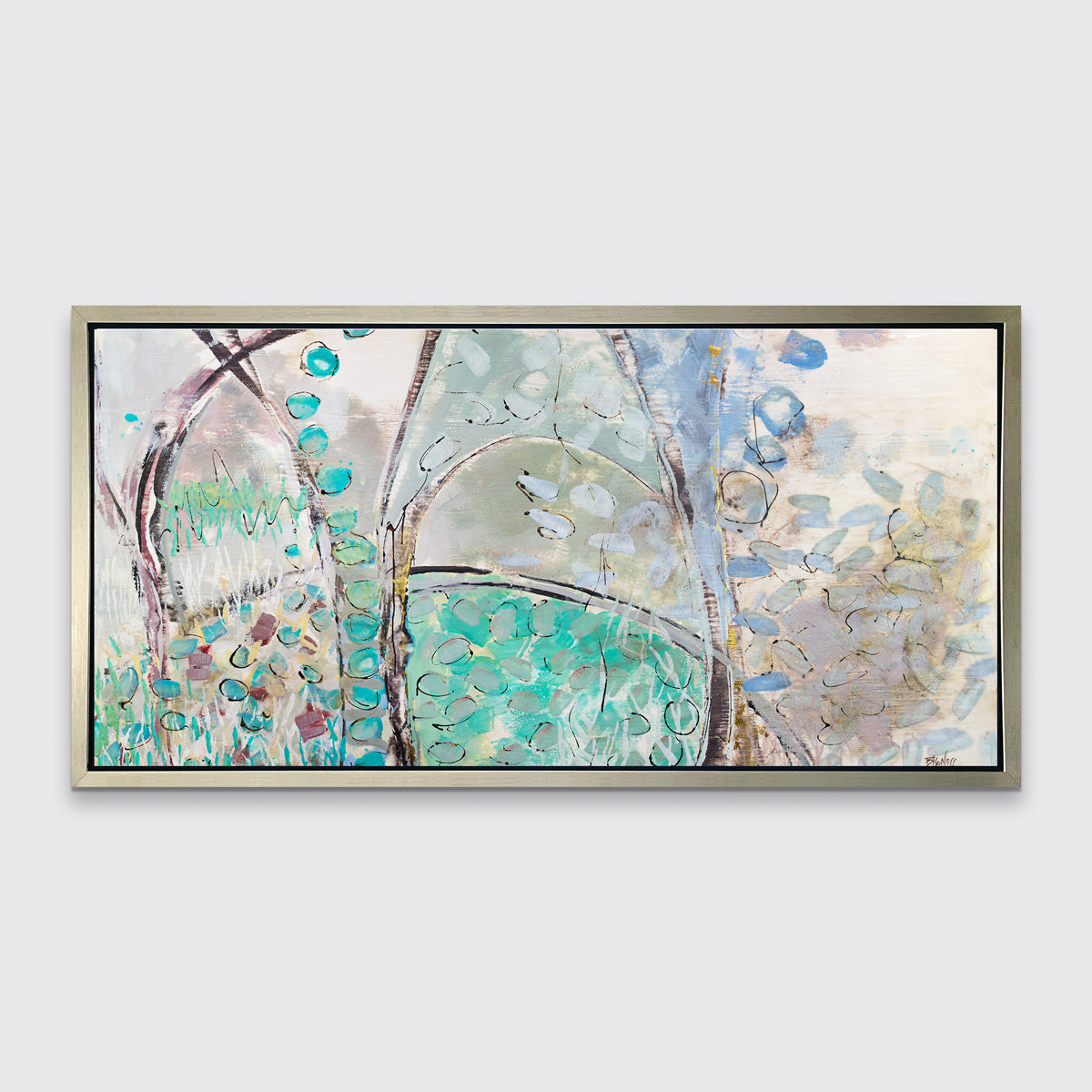 A teal, beige and mauve abstract landscape print in a silver floater frame hangs on a white wall.