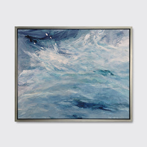 A blue, teal and white abstract print in a silver floater frame hangs on a white wall.