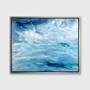 A blue, teal and white abstract print in a silver floater frame hangs on a white wall.