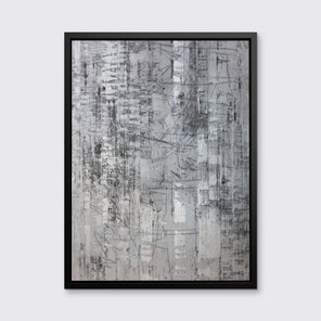 An abstract silver-grey limited edition art print by Ned Martin in a black frame hangs on a white wall.