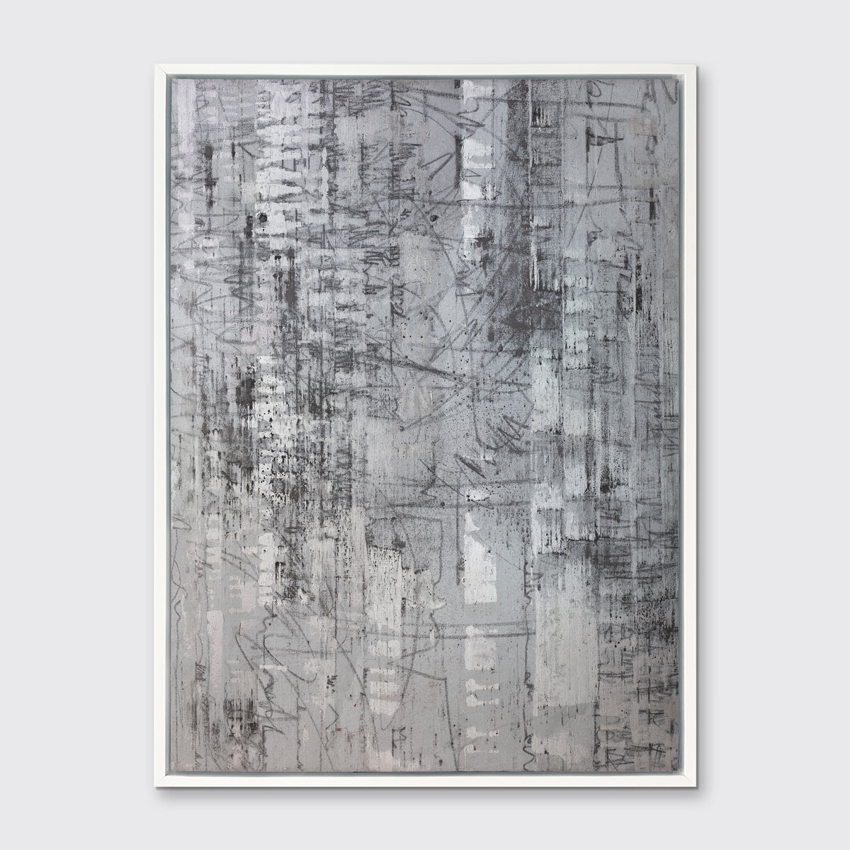 An abstract silver-grey limited edition art print by Ned Martin in a white frame hangs on a white wall.