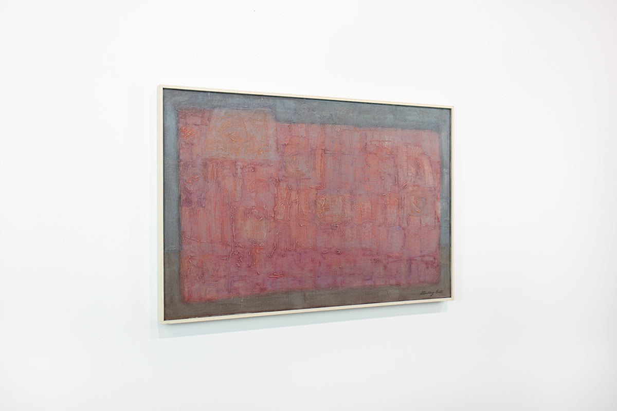 A framed red and grey abstract painting hangs on a white wall.