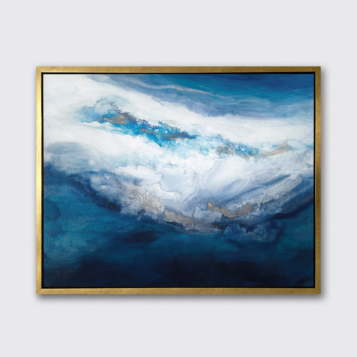 A blue, white, gold and teal abstract print in a gold floater frame hangs on a white wall.