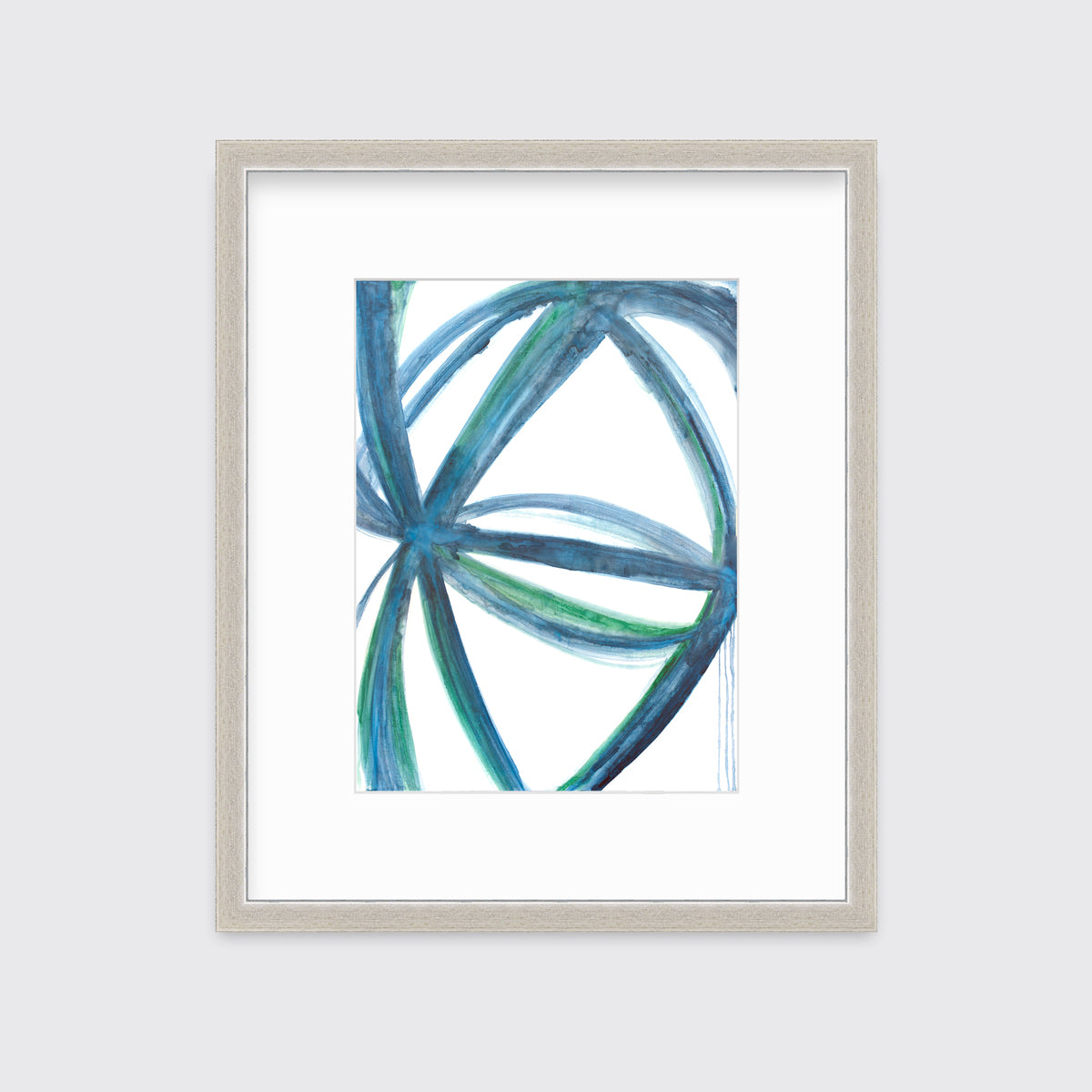 A blue, green and white abstract print in a silver frame with a mat hangs on a white wall.