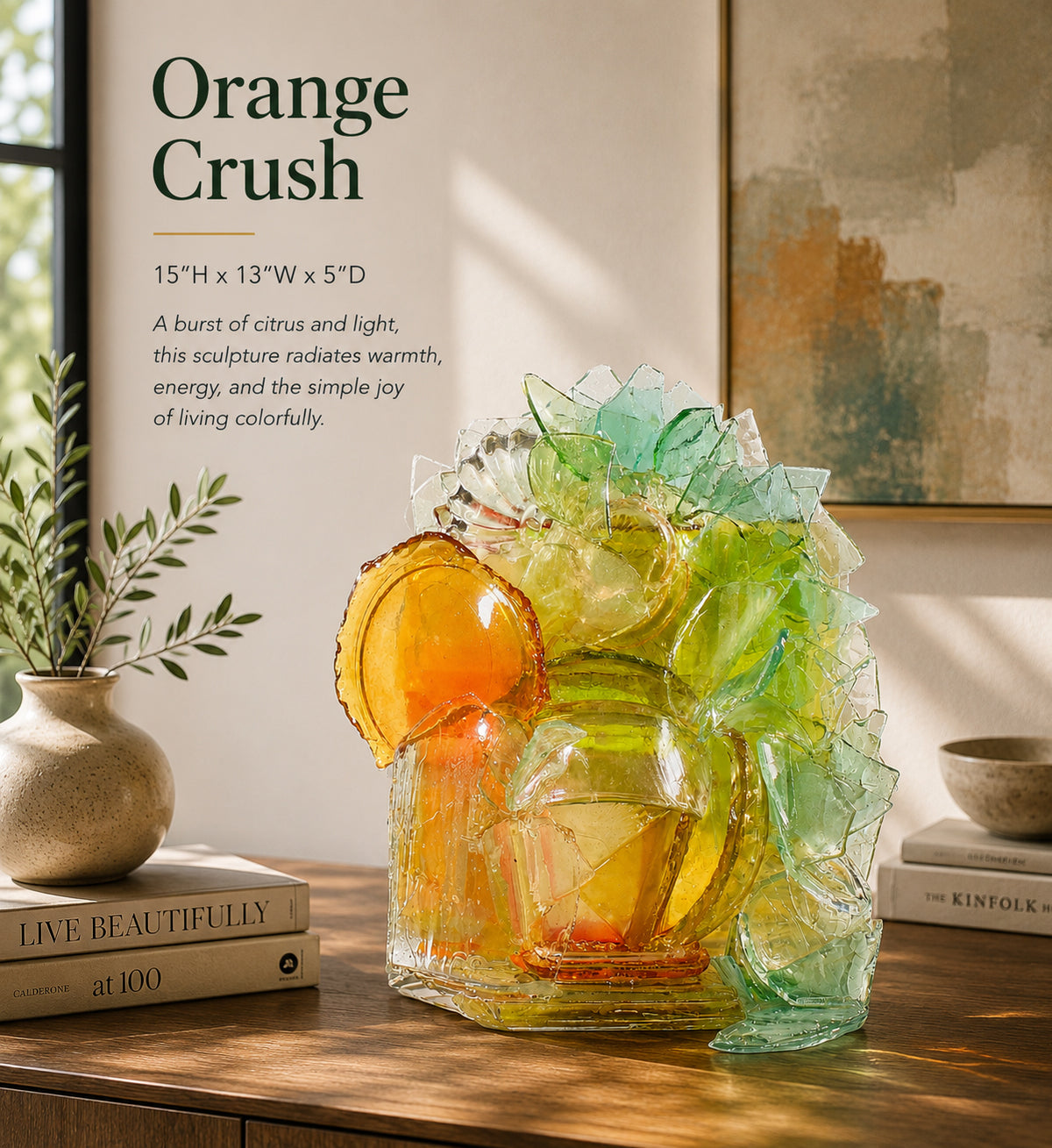 Colorful glass sculpture titled 'Orange Crush' on a wooden surface with books and a plant.