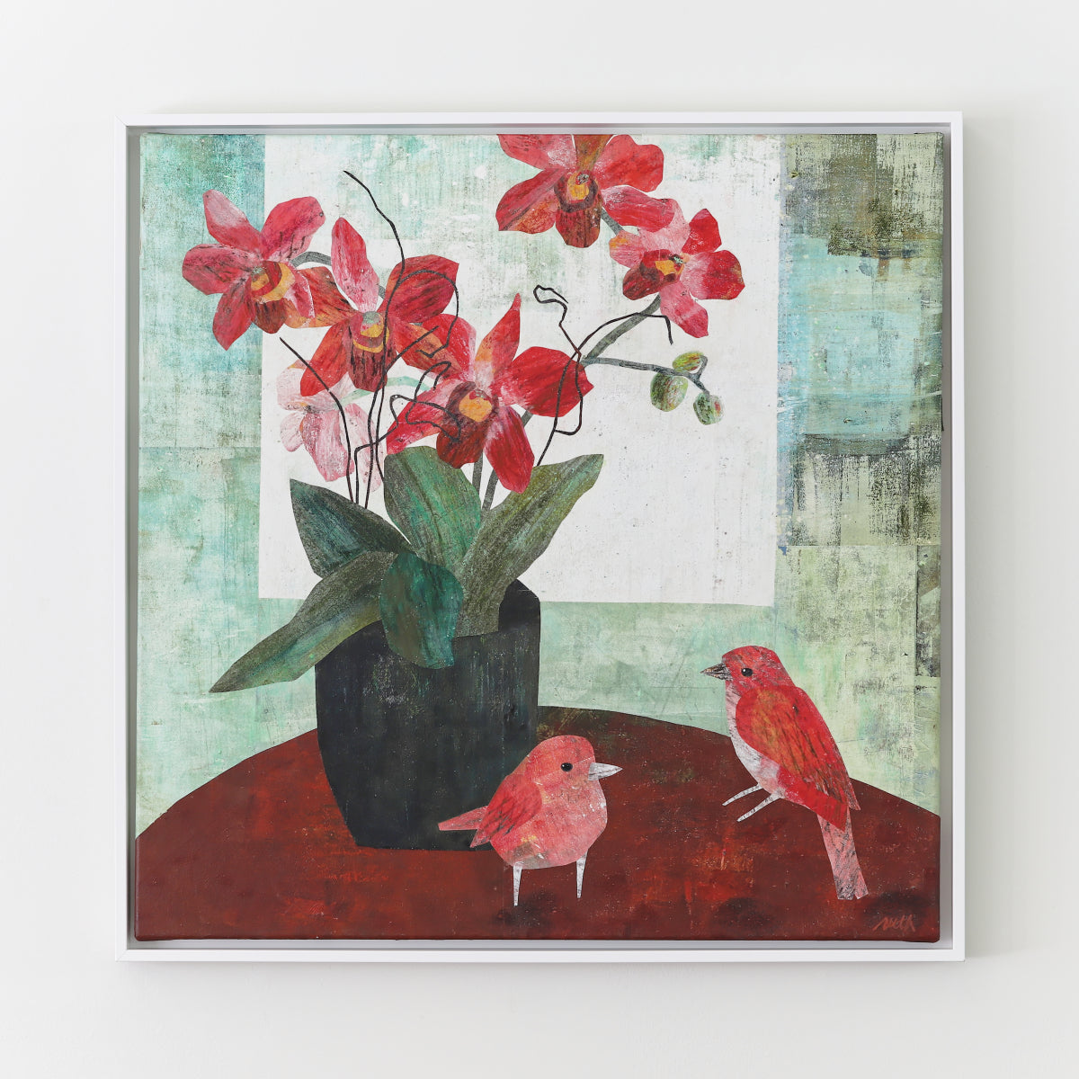 A framed square collage painting depicting red orchids in a black vase with two small red birds on a reddish-brown surface against a textured light green and white background.