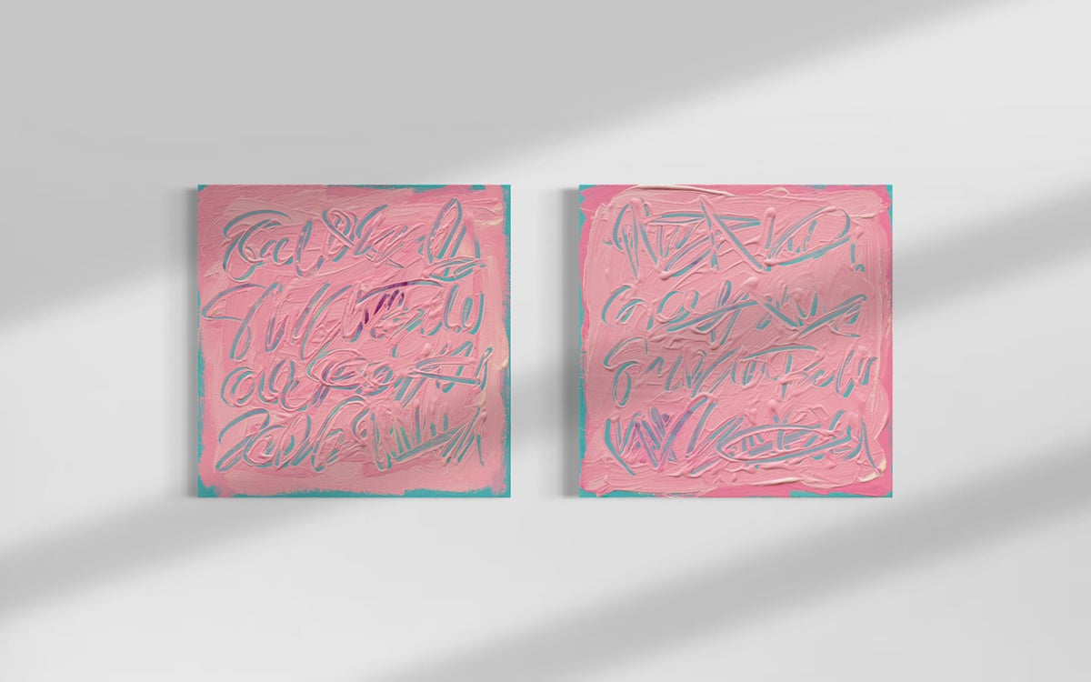 Two square pink text based paintings with writing into the surface with various tools, carving fluid script that reveals the teal color hidden below. Displayed side-by-side on a white wall with soft diagonal shadows.