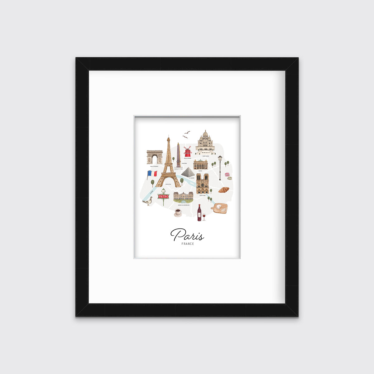 A multicolored map print of Paris, France with the famous landmarks in a black frame with a mat hangs on a white wall.