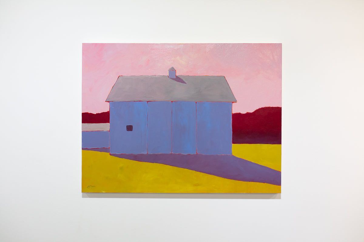 A warm-toned landscape painting of a barn in a field hangs on a white wall. 