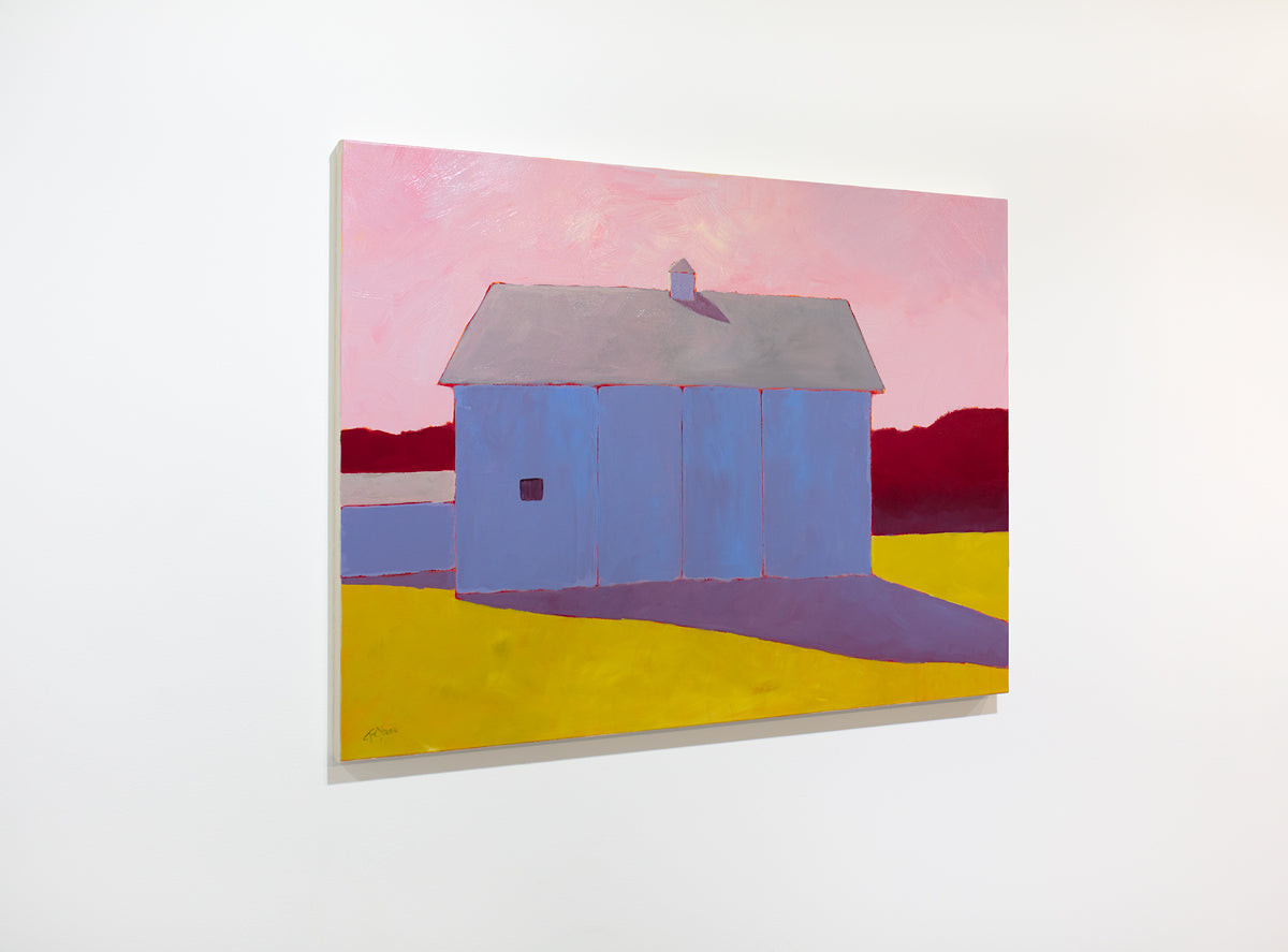 A warm-toned landscape painting of a barn in a field hangs on a white wall.