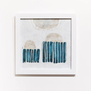 A blue, white, and beige abstract painting framed in a white frame hangs on a white wall.