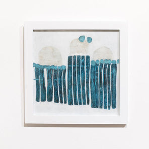 A blue, white, and beige abstract painting framed in a white frame hangs on a white wall. 