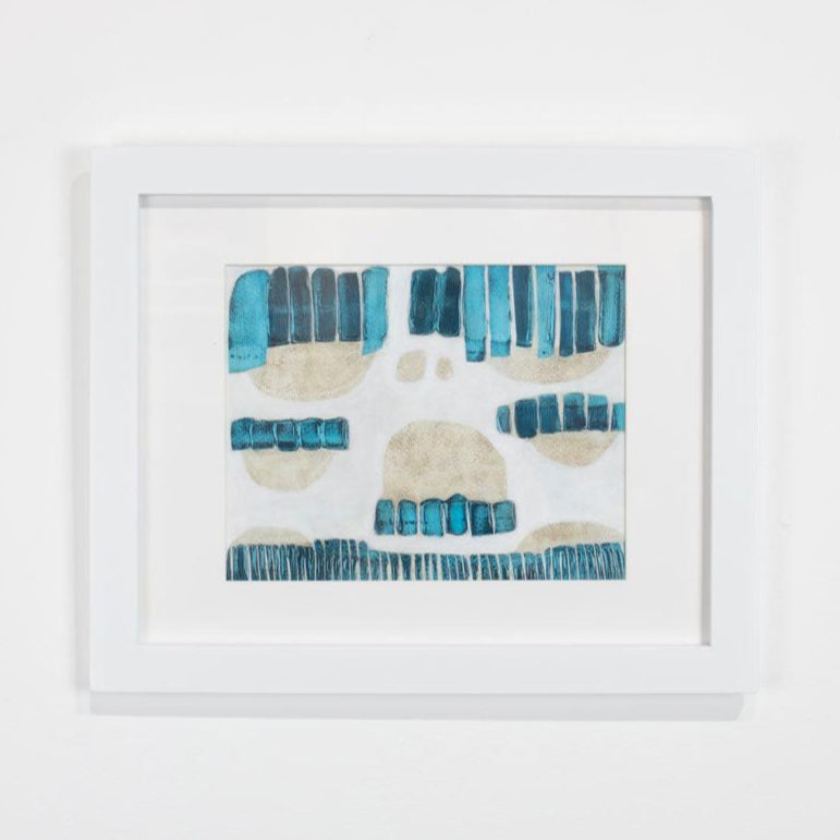 A blue, beige, and white abstract painting framed in a white frame hangs on a white wall. 