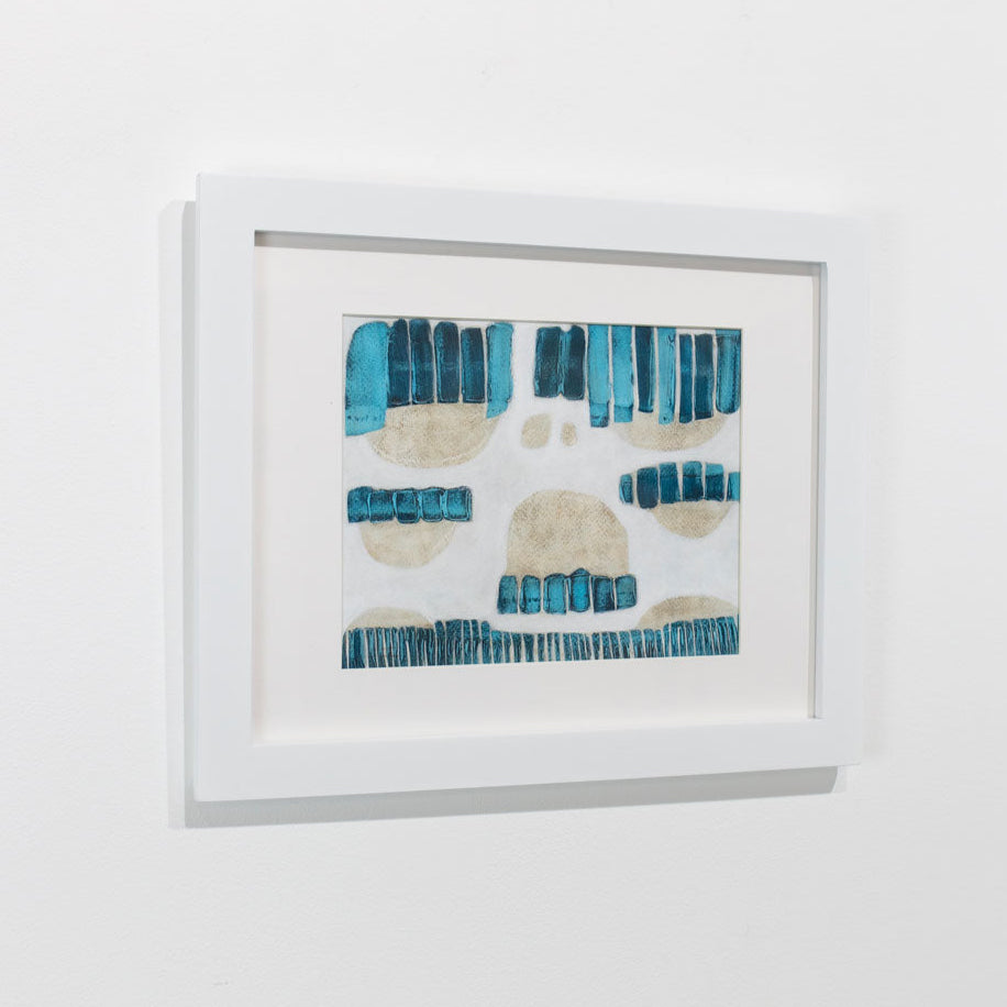 A blue, beige, and white abstract painting framed in a white frame hangs on a white wall.