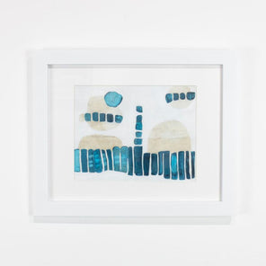 A blue, white, and beige abstract painting framed in a white frame hangs on a white wall. 