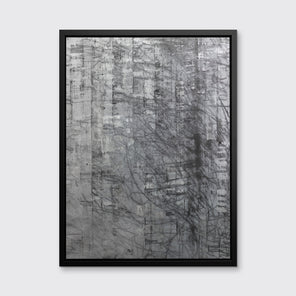 An abstract silver-grey limited edition art print by Ned Martin in a black frame hangs on a white wall.