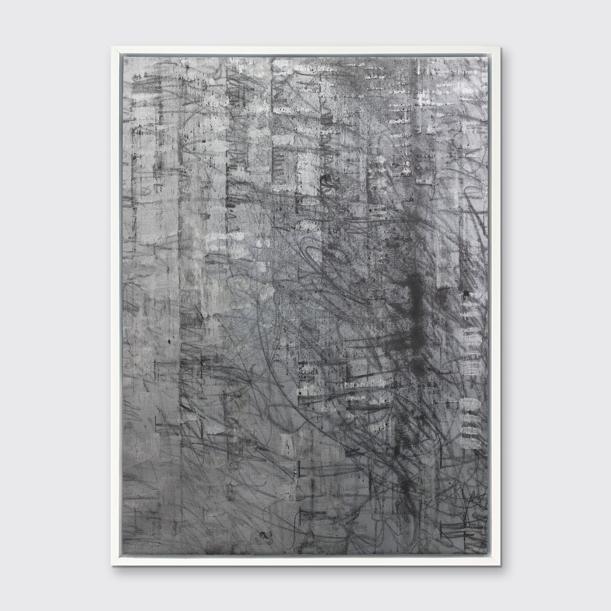 An abstract silver-grey limited edition art print by Ned Martin in a white frame hangs on a white wall.