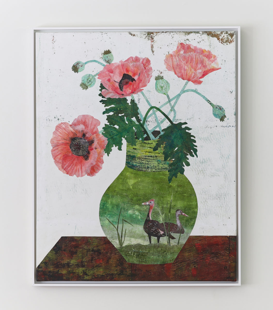 A framed still life collage featuring pink poppy flowers in a green textured vase with two small birds inside, displayed against a light neutral wall.