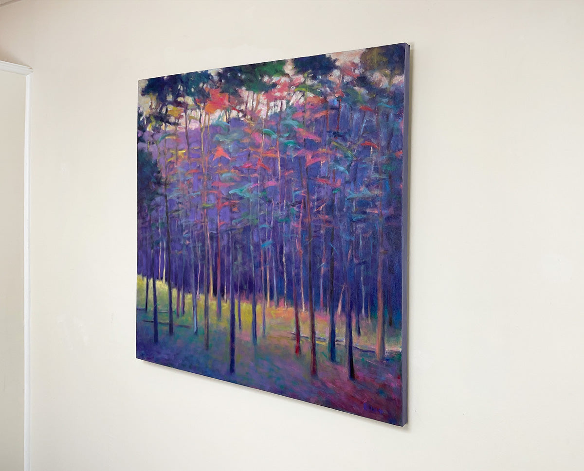 Colorful abstract painting of a forest on a white wall