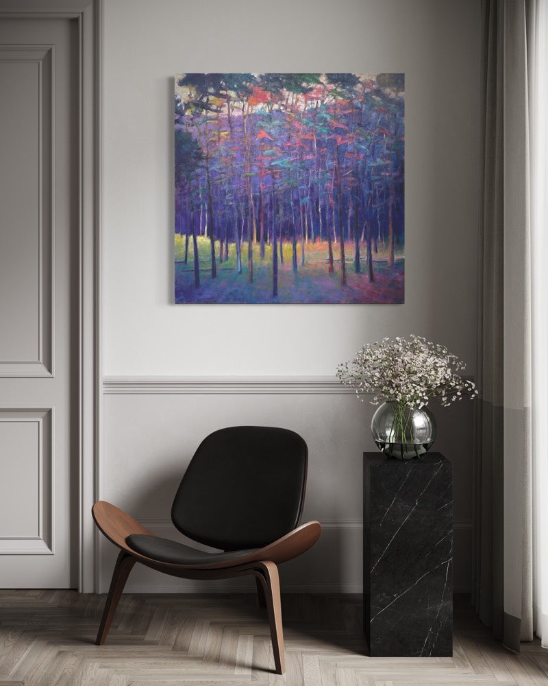 Modern interior with a black chair, marble side table, and abstract forest painting on the wall.