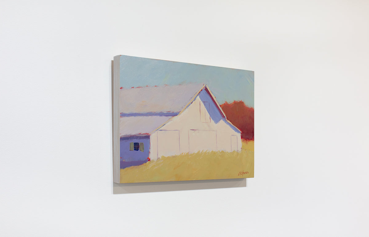 A landscape painting of a barn in a field hangs on a white wall.