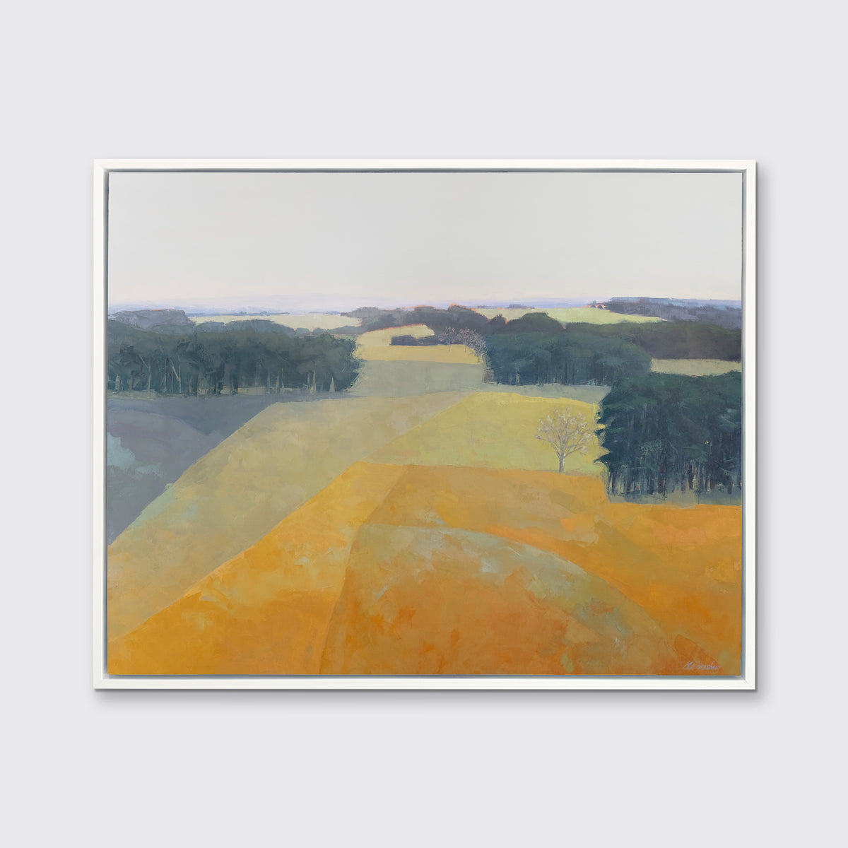 A light blue, green and light orange abstract landscape print in a white floater frame hangs on a white wall.