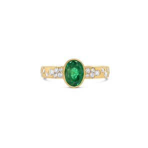 Gold ring with a green gemstone and diamond accents on a white background