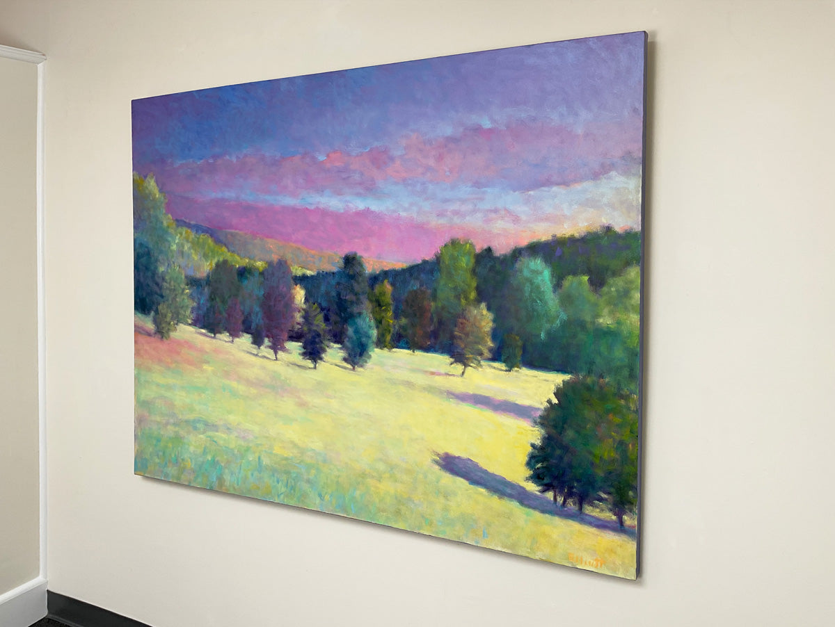 Painting of a landscape with trees and a field on a white wall.