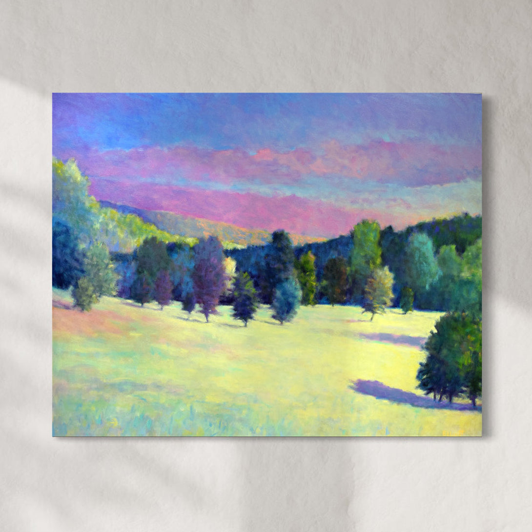 Painting of a landscape with trees and a colorful sky on a white wall.