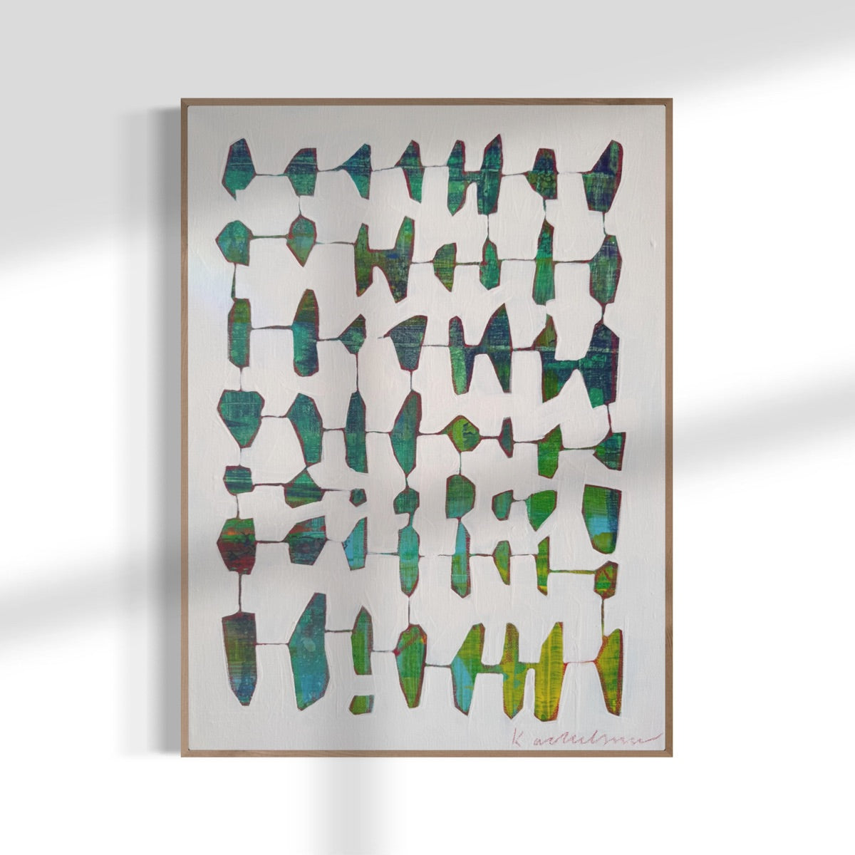 Framed abstract art piece with geometric shapes on a white background.