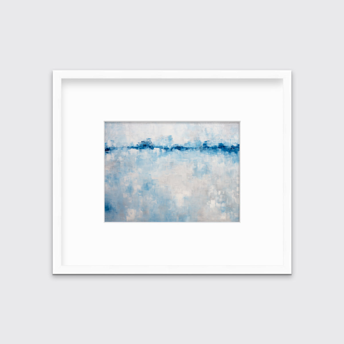A blue and white abstract print in a white frame with a mat hangs on a white wall.