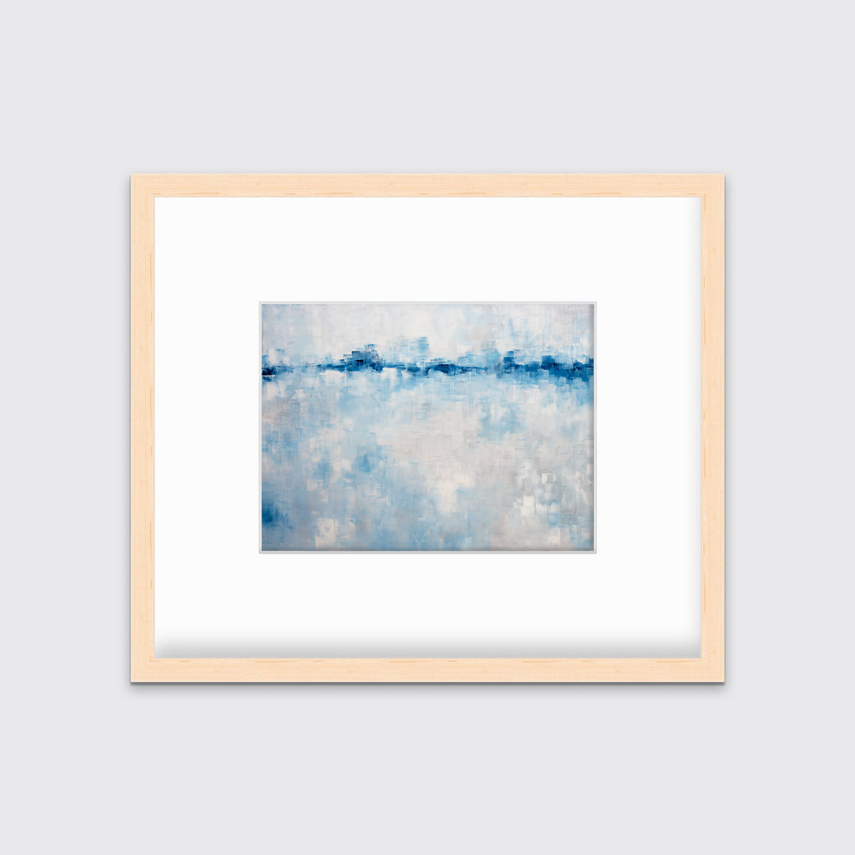 A blue and white abstract print in a natural wood frame with a mat hangs on a white wall.
