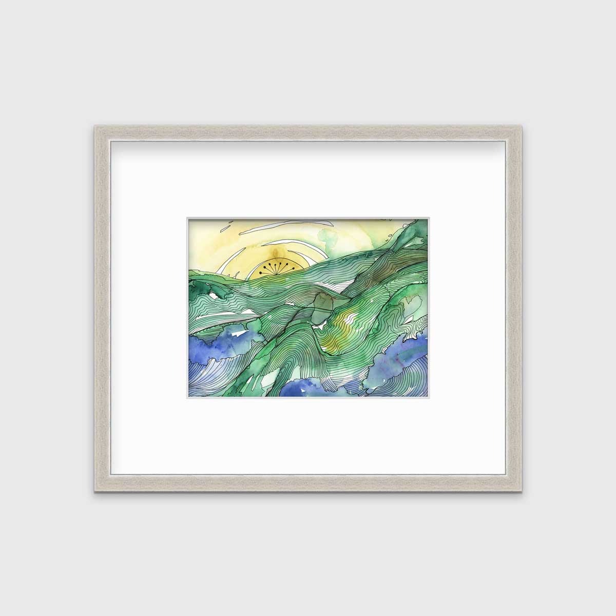 A yellow and green landscape illustration print framed in a silver frame with a mat hangs on a white wall.