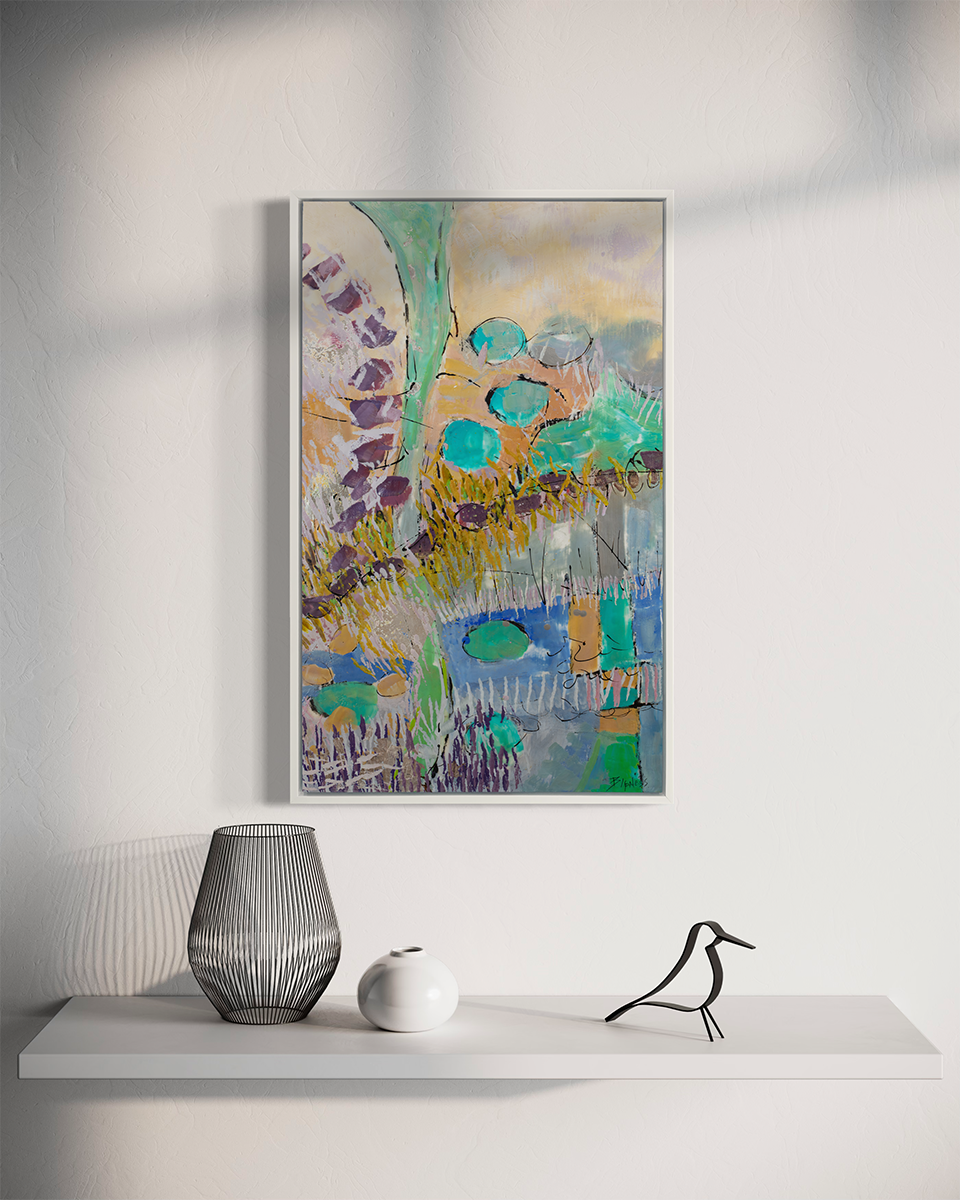 A teal, orange, purple and yellow abstract landscape print in a silver floater frame hangs on a white wall above a white floating shelf with a black wire vase, a short rounded white vase and a bird decoration.