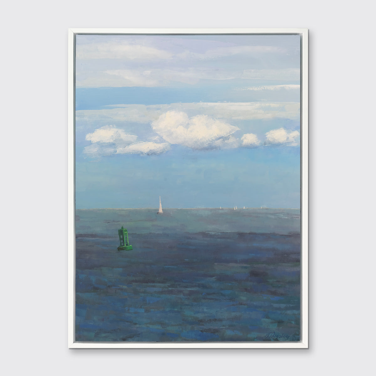 A coastal seascape print in a white floater frame hangs on a white wall.