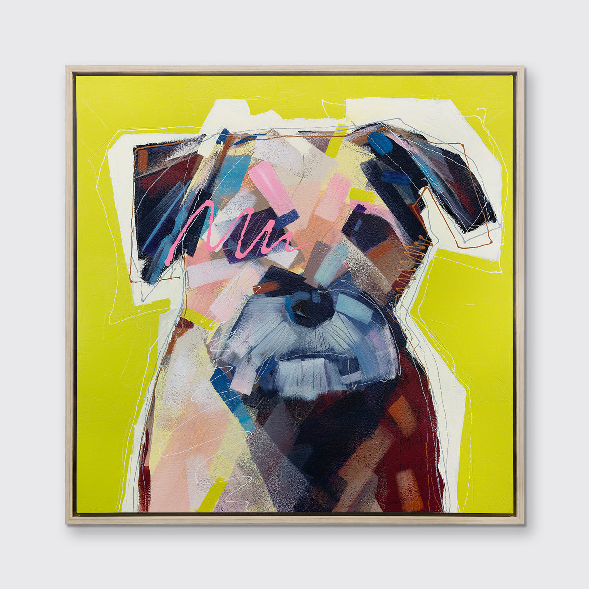 A multicolored abstract dog print in a white oak wood floater frame hangs on a white wall.