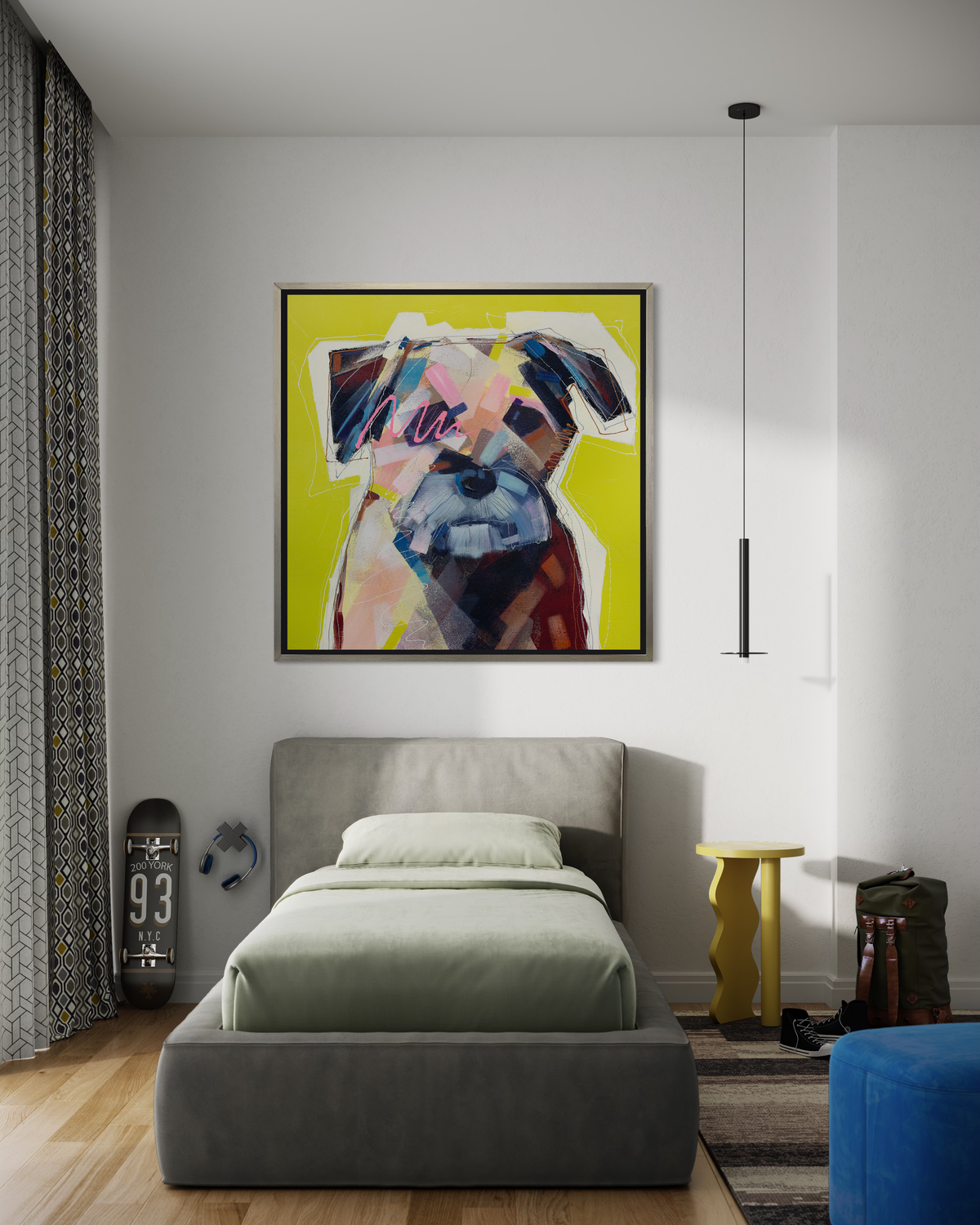 A multicolored abstract dog print in a silver floater frame hangs on a white wall above a twin bed with light green bedding, a yellow modern side table, a skateboard and backpack.