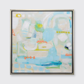 A light blue, beige, light green and orange abstract print in a silver floater frame hangs on a white wall.