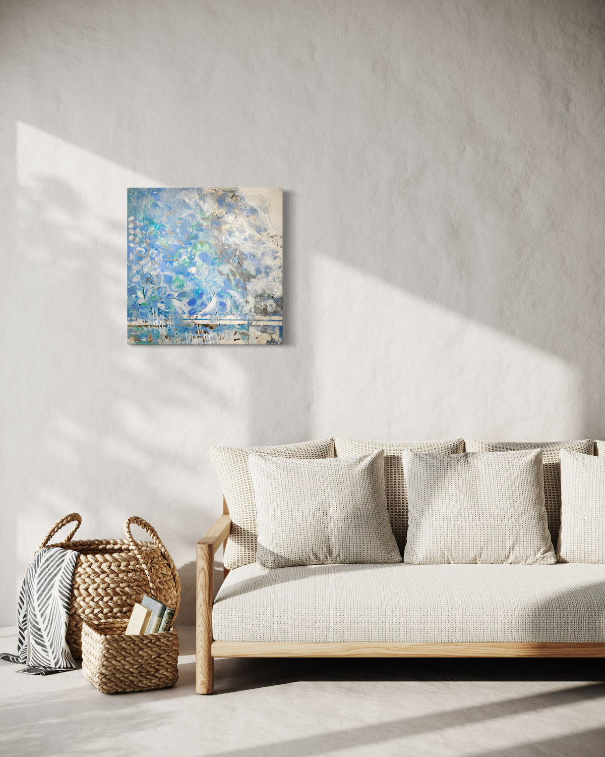 Living room with a beige sofa, woven basket, and abstract painting on a white wall.