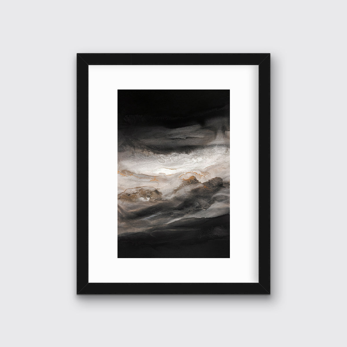A black, white, beige and gold abstract print in a black frame with a mat hangs on a white wall.
