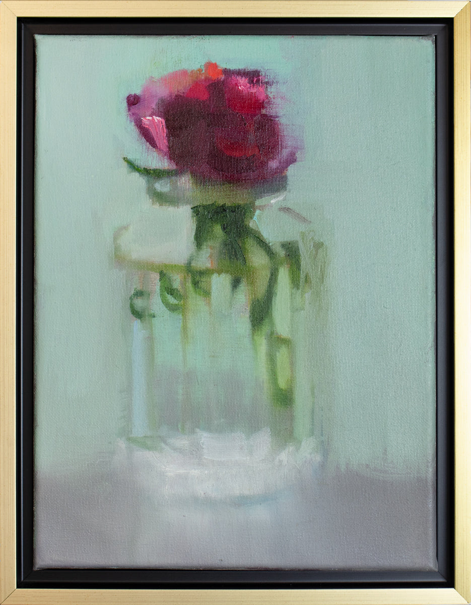 A small framed painting of a red flower in a clear glass vase, framed in a gold floating frame.