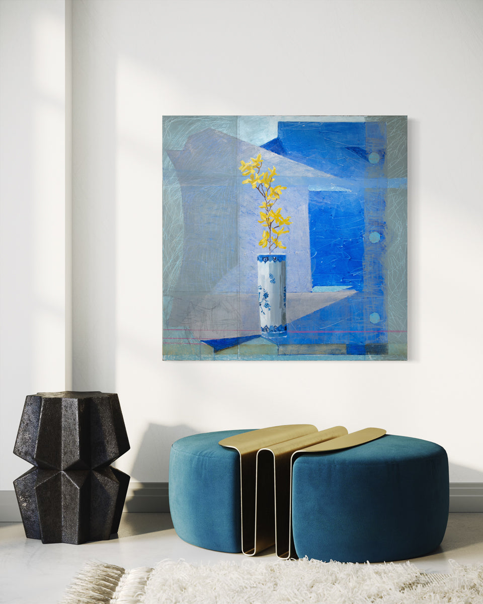 An abstracted blue painting with a vase with yellow flowers in the foreground hangs on a white wall above a modern blue and gold seat, white rug and black sculpture. 