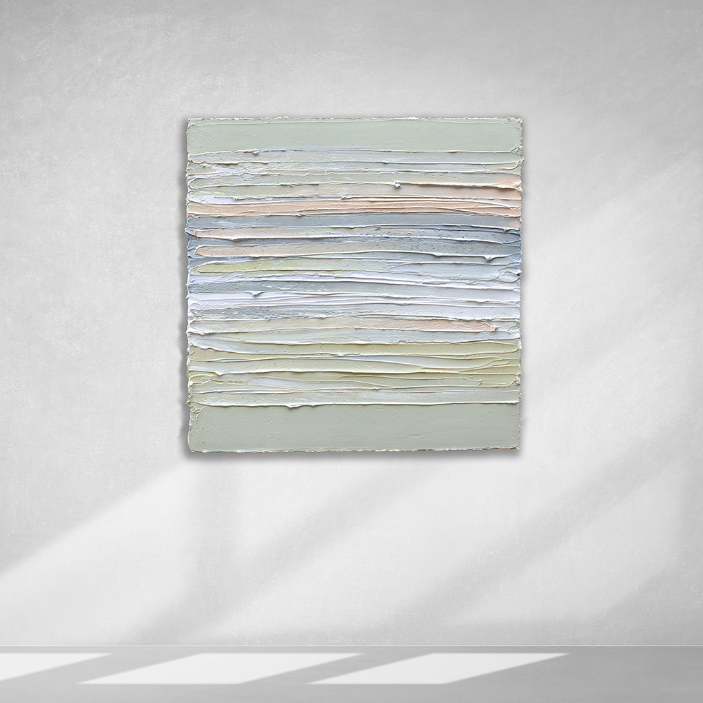 A peach, grey, white, celadon and sage green thickly textured painting hanging on a white wall by Teodora Guererra.