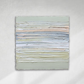 A peach, grey, white, celadon and sage green thickly textured painting hanging on a white wall by Teodora Guererra.