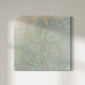 A pastel green, turquoise and yellow painting with floral motifs is hung on a gallery wall. The painting is wired and ready to hang.