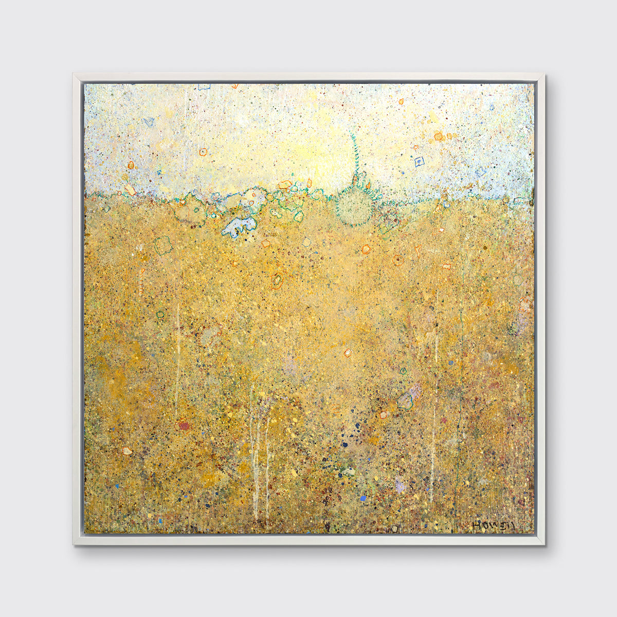 A yellow abstract landscape print in a white floater frame hangs on a white wall.